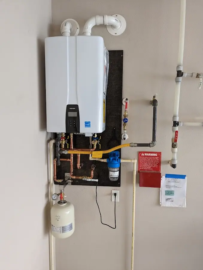 Professional plumber installing copper piping in a Oak Creek home